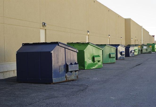 a yellow construction dumpster filled with waste materials in Edroy, TX